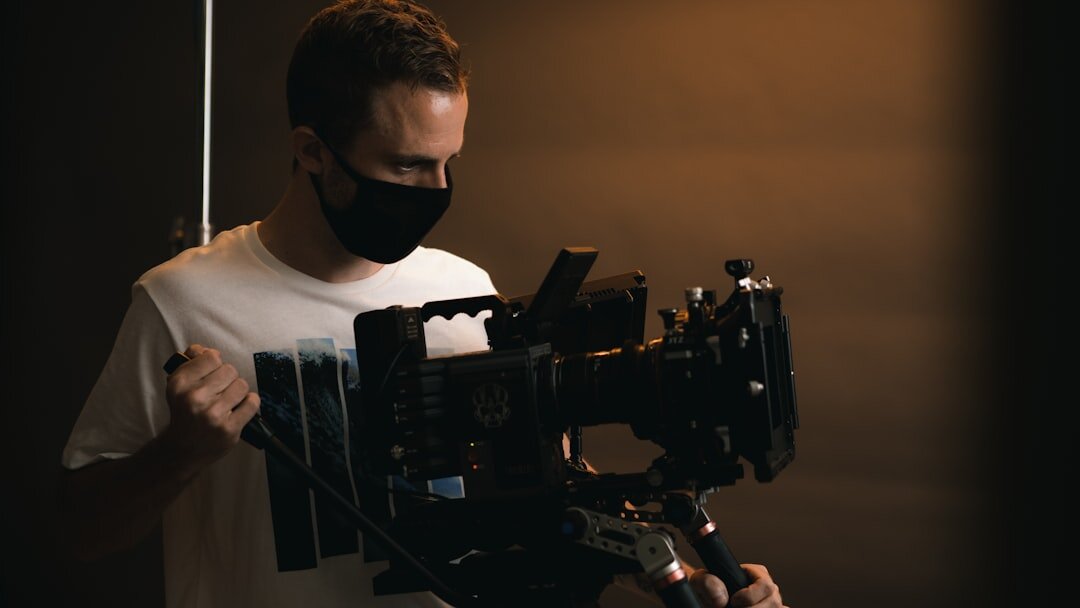 Camera operator filming in a television studio with a broadcast camera